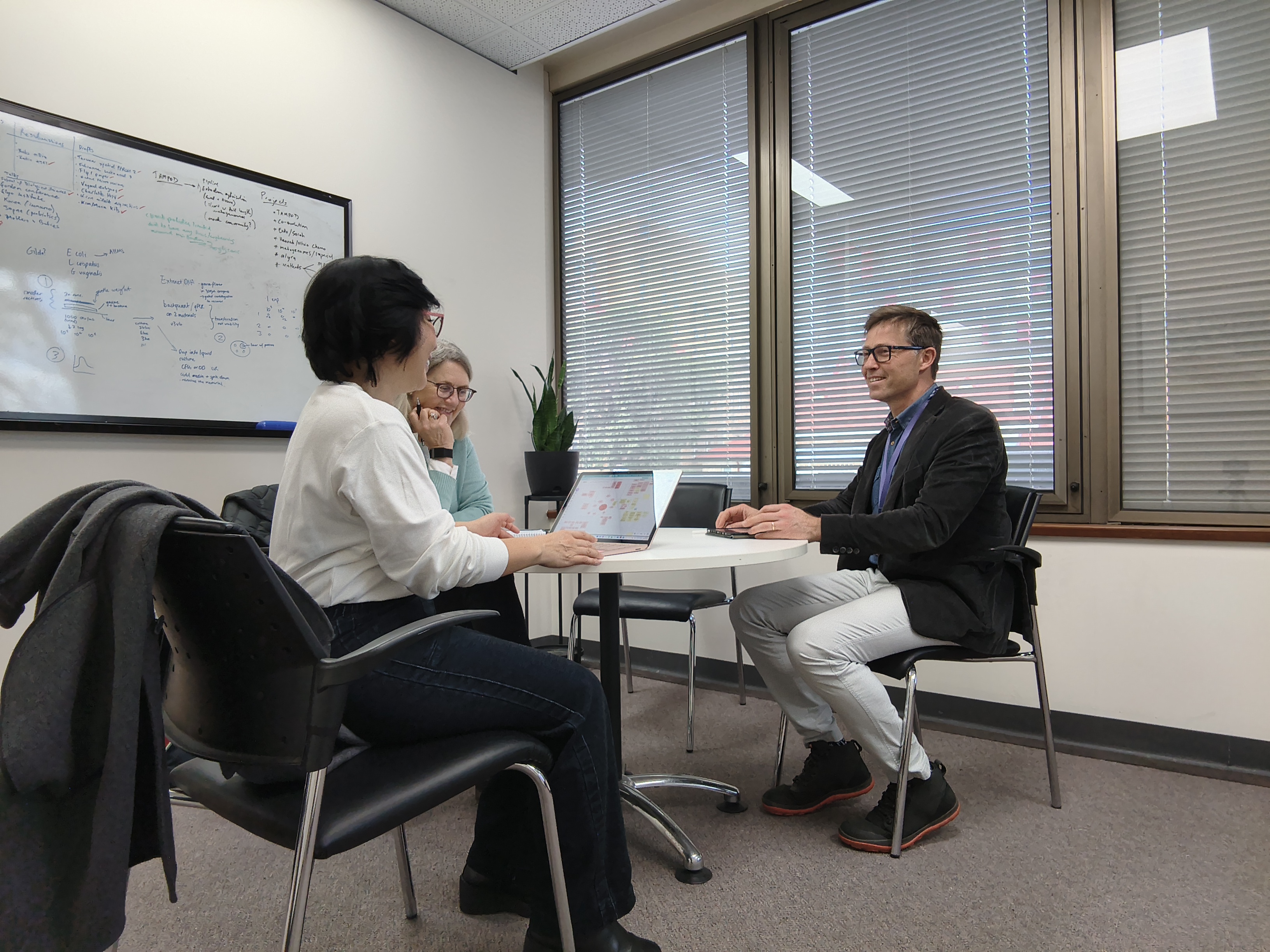 three people sitting in an office